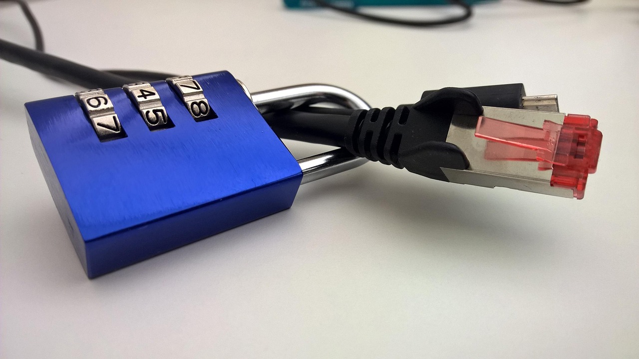 A metal combination padlock resting on a laptop keyboard