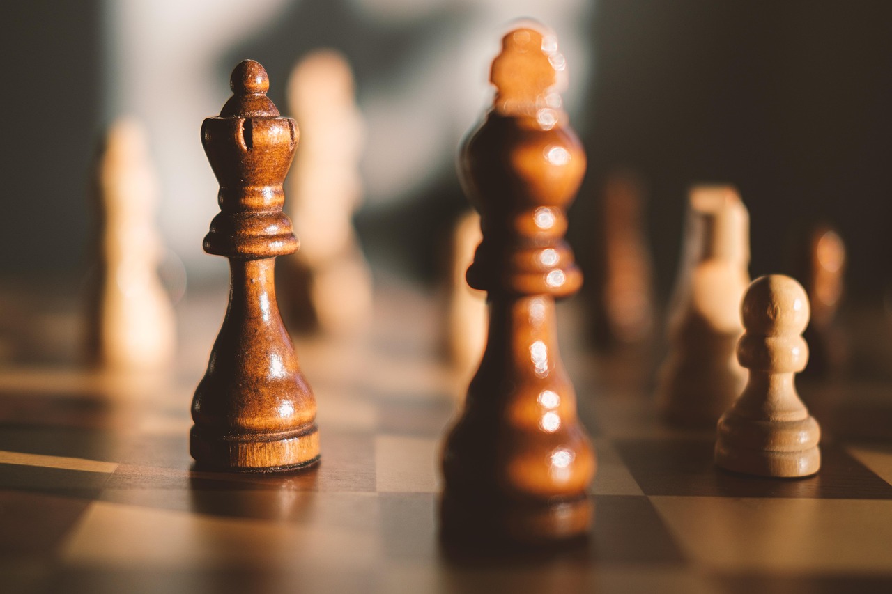 Chess pieces set up on a board, ready for play